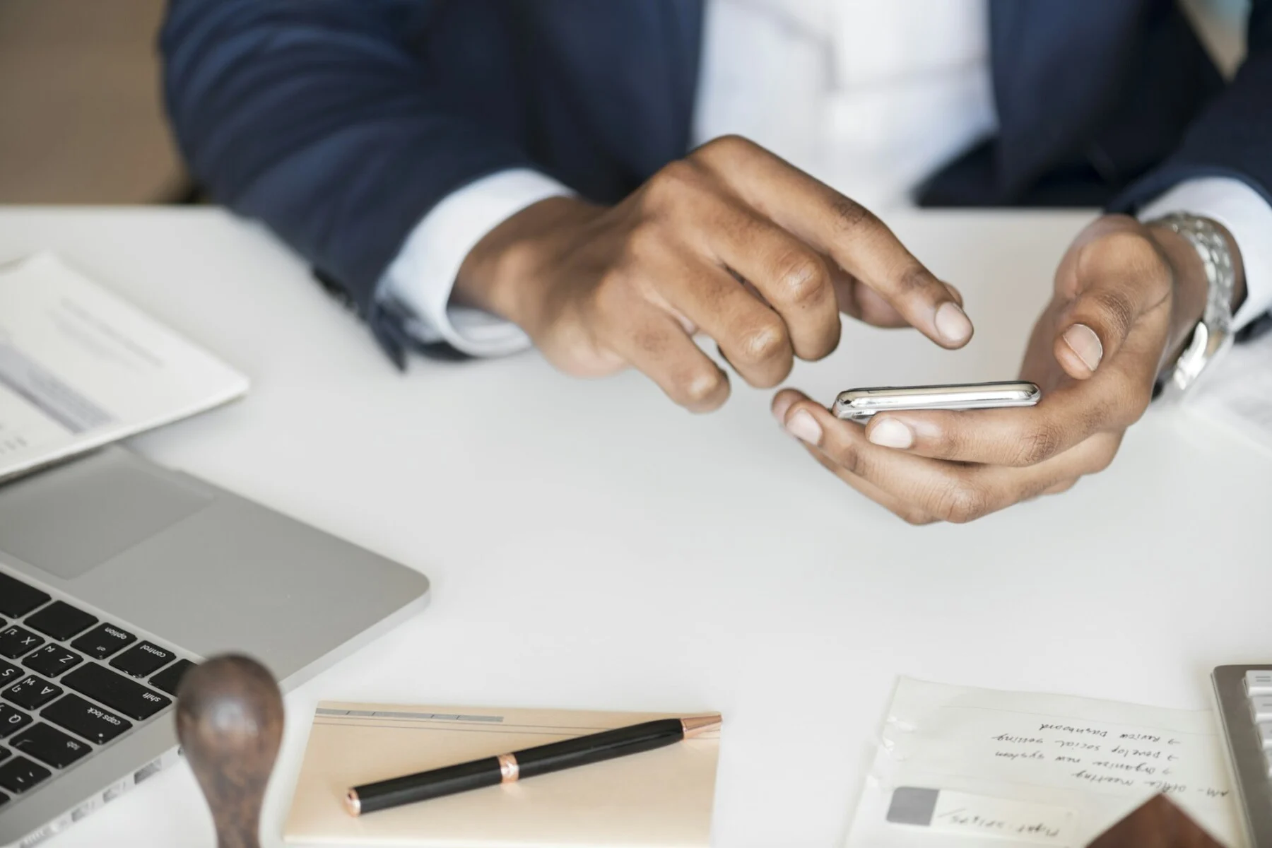 Closeup of businessman using mobile phone