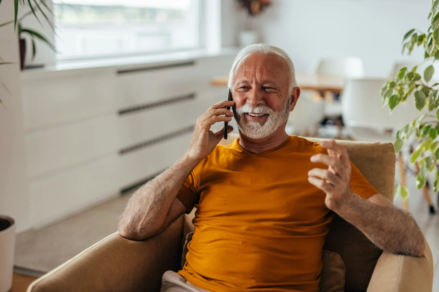 Senior man, calling his doctor, from home.